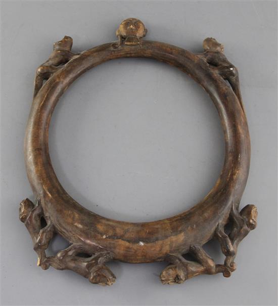 An African? carved wood hoop necklace, decorated with a bearded mask and monkeys, 31cm